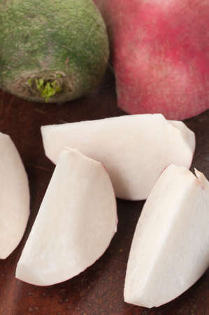 Radish cuts on a timber board, close upの写真素材