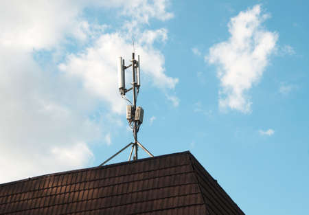 The cellular communication aerial on a building roofの写真素材