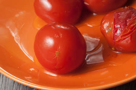 Marinated tomatoes on a plate, close up shotの写真素材