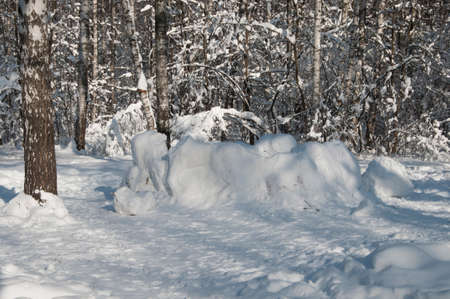 Winter landscape in a  park with snow fortress in a sunny day