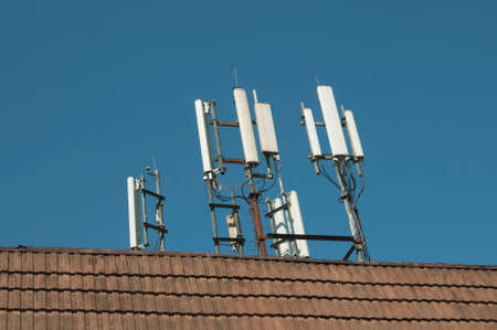 The cellular communication aerial on a building roofの写真素材