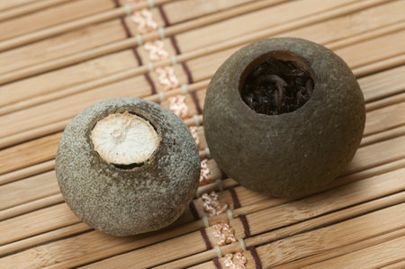 Pu'er tea in tangerine on a bamboo background, close upの写真素材