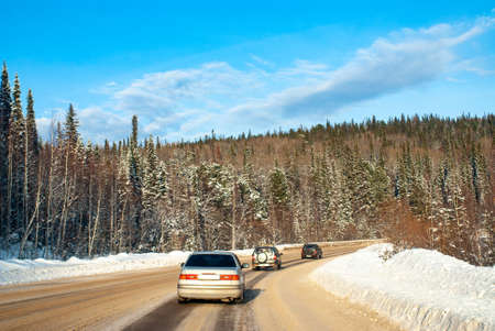 Winter track in the Siberian taiga on a sunny frosty day. Ascent to the pass. Selective focus.の写真素材