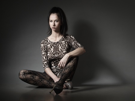 Girl sitting on the floorの写真素材