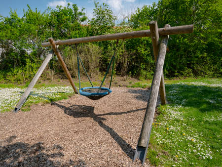 Lone swing seat in a summer field in Germany