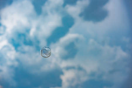Single soap bubble on sky background in Germany
