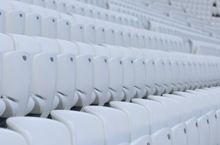 Empty white seats at the american football stadium during isolation periodの写真素材