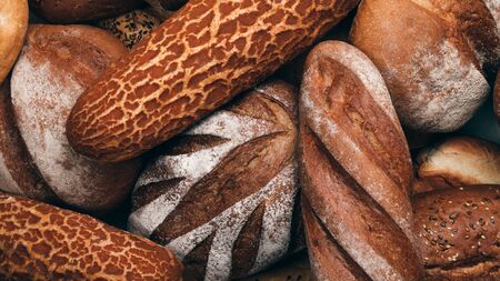 Many various wholegrain baked breads top view close-upの写真素材