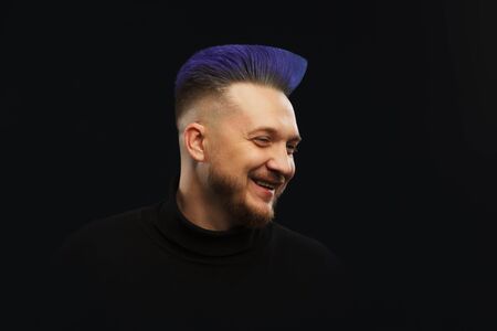 Man with blue or teal hair over darkの写真素材