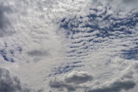 Cirrus and cumulus clouds against the blue sky.の写真素材