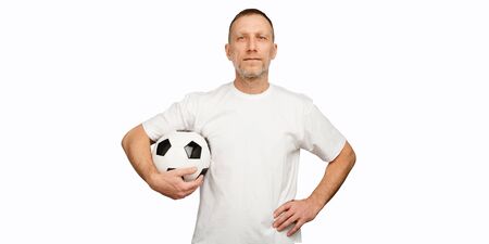 One man holds a soccer ball in akimbo posing.の写真素材
