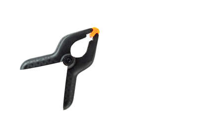 Single black plastic spring clamp isolated over white background.の写真素材