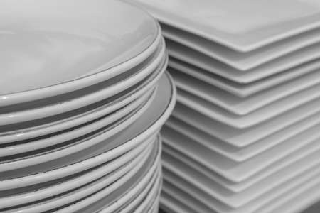 Stack of white porcelain crockery. Ceramic dishware pile.の写真素材