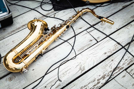 Saxophone on wooden weathered and peeled white floor.の写真素材