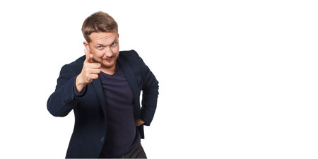 Man point to viewer while standing against white background.