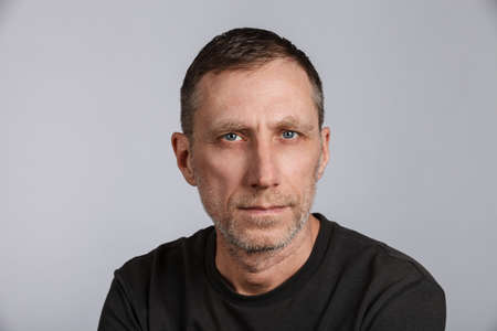 Beard man wearing t-shirt on light gray background. Studio shot.の写真素材