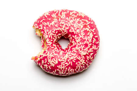 bitten-into donut doughnut with strawberry icing glazeの写真素材