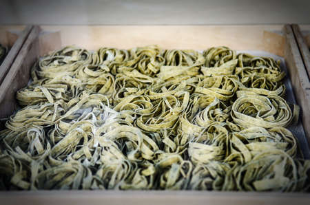 fresh spinach noodles in a wooden boxの写真素材