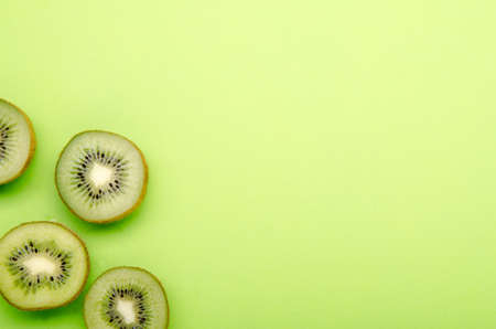 kiwis on a green pastel backgroundの写真素材