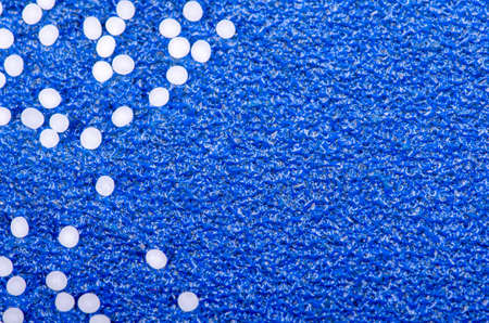 homeopathic globules on a blue textured  surface with copy space