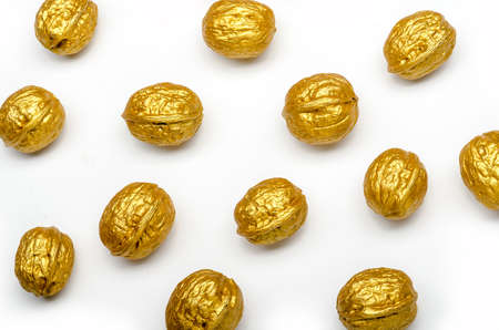 some golden walnuts on a white background, isolated