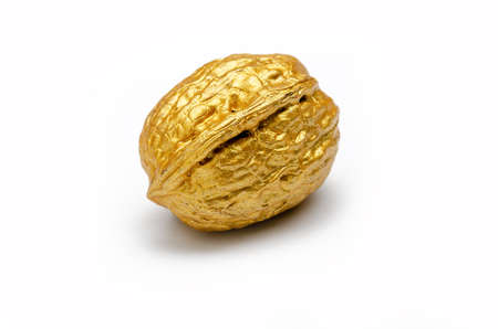 one golden walnut on a white background, isolated