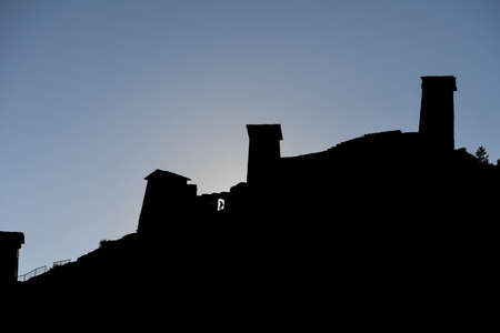 Caucasus, Georgia, Tusheti region, Omalo. Silhouette of man walking in the the old fort of upper...