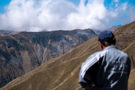 Caucasus, Georgia, Tusheti region, Omalo. A man overlooks at caucasus mountains in Georgiaの写真素材