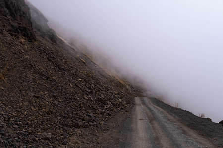 Caucasus, Georgia, Tusheti region, Omalo. Foggy road on a mountain side in Georgiaの写真素材