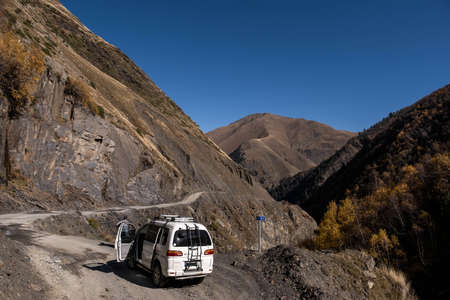 Caucasus, Georgia, Tusheti region, Omalo. A man repairs a car on the road to Omalo - Tusheti with...