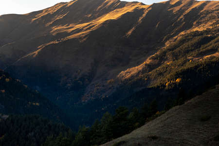 Caucasus, Georgia, Tusheti region, Omalo. A village on a mountainside is lit by the setting sun in the Tusheti region.の写真素材