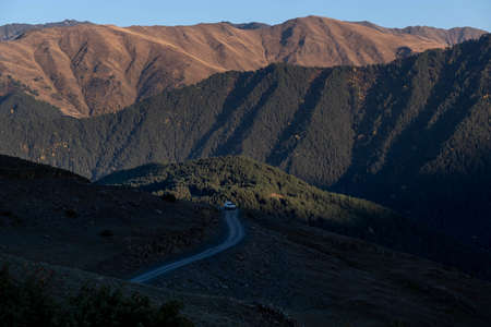 Caucasus, Georgia, Tusheti region, Omalo. A car stands on a dirt road in the Tusheti region near the Omalo villageの写真素材