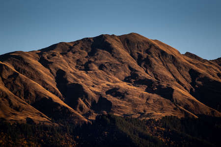 Caucasus, Georgia, Tusheti region, Omalo. A mountain is lit by the setting sun in the Tusheti region.の写真素材