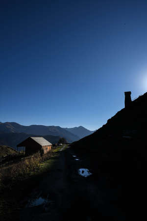 Caucasus, Georgia, Tusheti region, Omalo. A pathway crosses a house on the left and an ancient tower on the right in Omala - Tushetiのeditorial素材