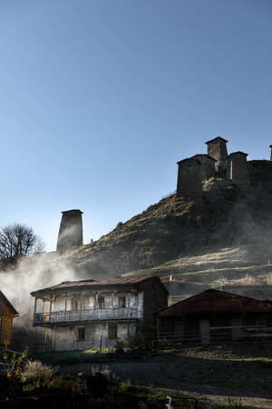 Caucasus, Georgia, Tusheti region, Omalo. The old fort overlooks the village of upper Omalo drowned in the smoke of a chimneyのeditorial素材