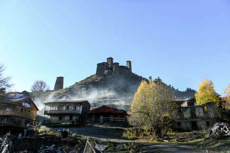 Caucasus, Georgia, Tusheti region, Omalo. The old fort overlooks the village of upper Omalo drowned in the smoke of a chimneyのeditorial素材