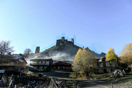 Caucasus, Georgia, Tusheti region, Omalo. The old fort overlooks the village of upper Omalo drowned in the smoke of a chimneyのeditorial素材