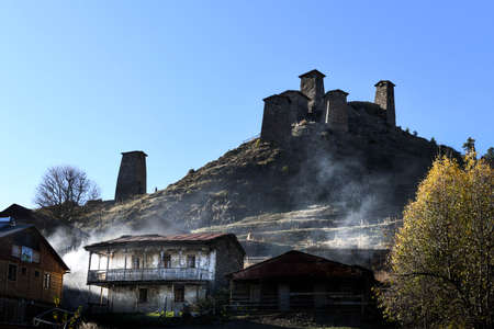 Caucasus, Georgia, Tusheti region, Omalo. The old fort overlooks the village of upper Omalo drowned in the smoke of a chimneyのeditorial素材