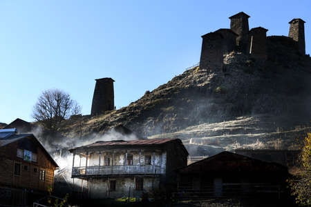 Caucasus, Georgia, Tusheti region, Omalo. The old fort overlooks the village of upper Omalo drowned in the smoke of a chimneyのeditorial素材