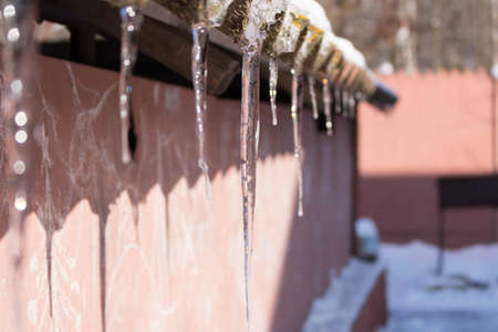 Big icicle on roof in Winter day.の写真素材