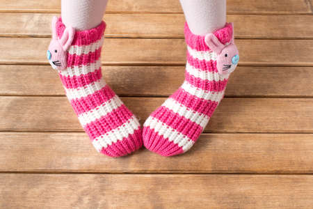Funny baby socks on the background of wooden table の写真素材