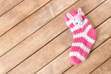 Funny baby socks on the background of wooden table の写真素材