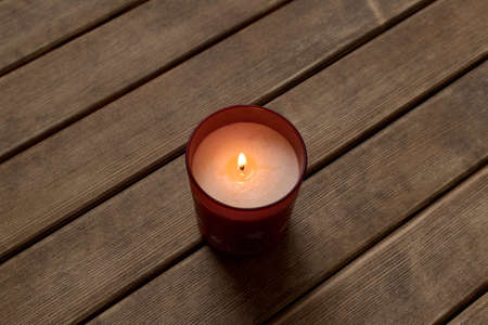 Burning candle on wooden table background .の写真素材