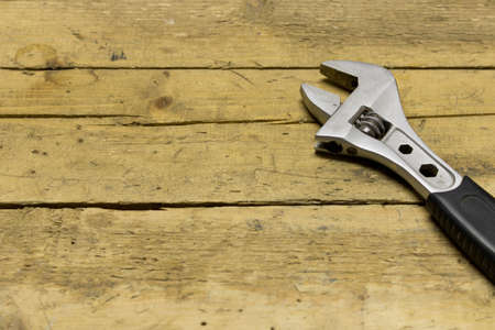 Adjustable wrench on a wooden workbench .の写真素材