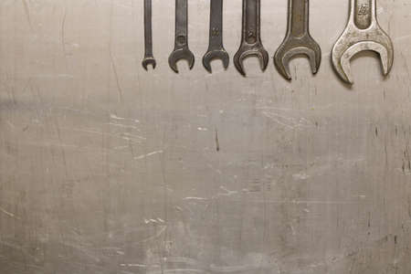 A set of wrenches on metal sheet