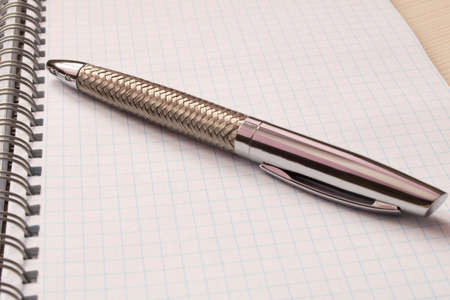 A pen and a Notepad on the table . Selective focus .の写真素材