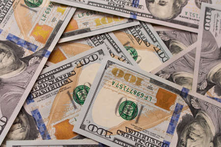 A lot of hundred dollar bills scattered on the table .の写真素材
