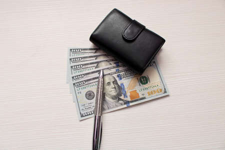 A lot of hundred dollar bills scattered on the table .の写真素材