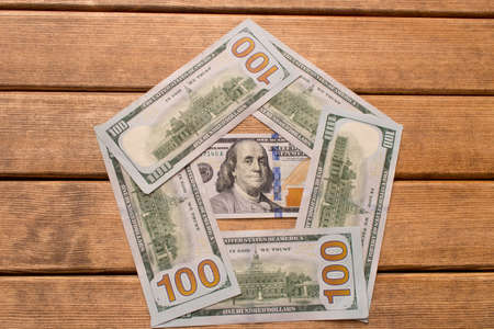 Hundred dollar bill with a smartphone on the table .の写真素材