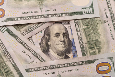 Hundred dollar bill with a smartphone on the table .の写真素材